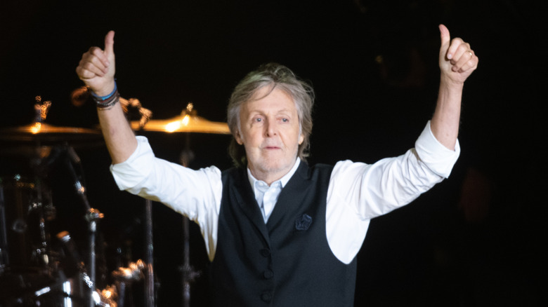 Paul McCartney doing thumbs-up onstage