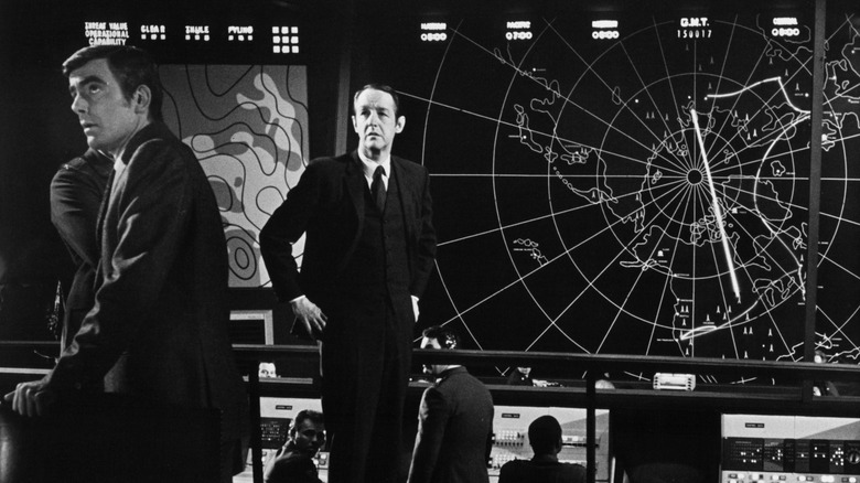 Government officials listening to Colossus' decrees