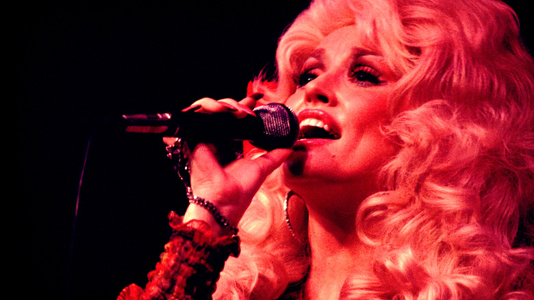 Dolly Parton singing on stage.