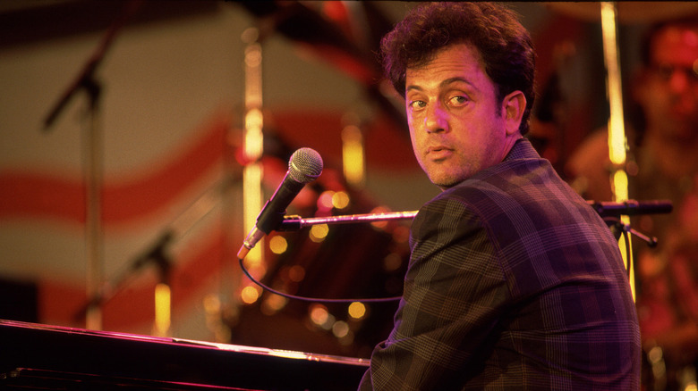 Billy Joel sat at piano looking backward