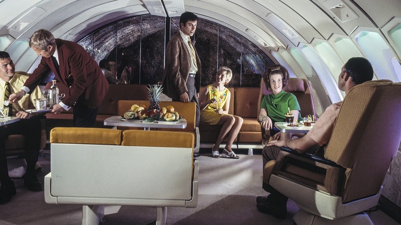 Passengers enjoying cocktails at a lounge onboard a plane