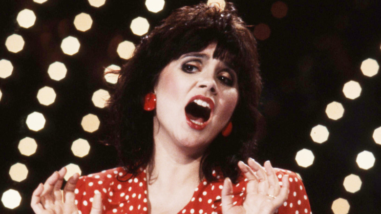 Linda Ronstadt in red dress singing