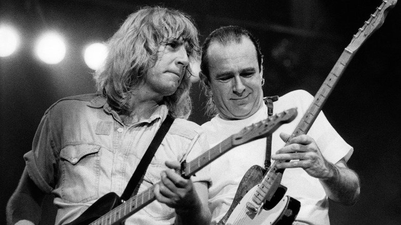 Rick Parfitt and Francis Rossi of Status Quo playing guitars on stage