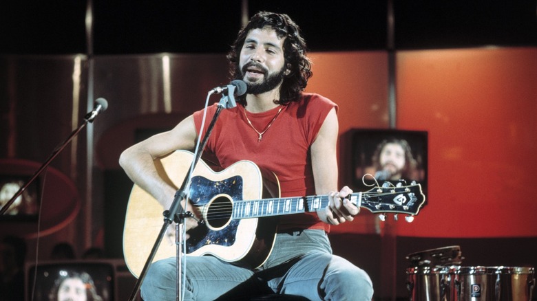Cat Stevens singing into microphone