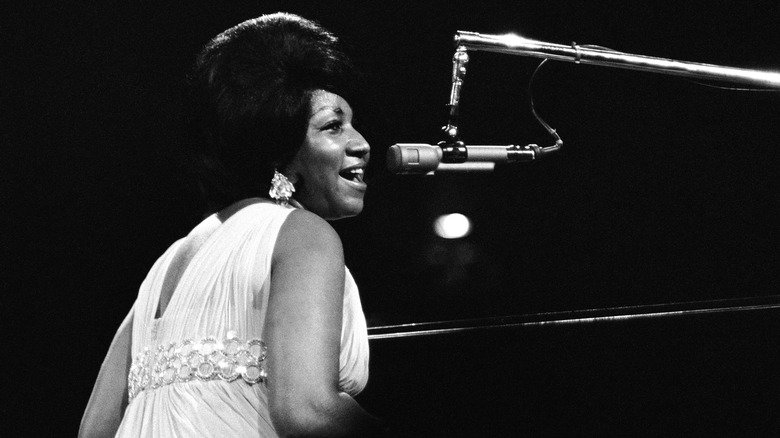 Aretha Franklin singing at a piano