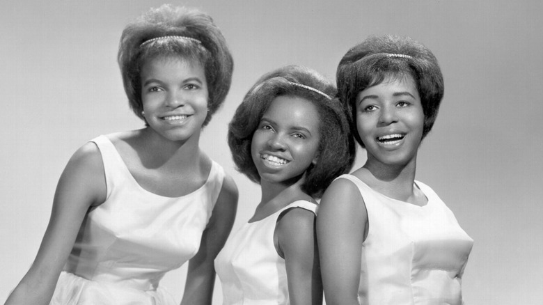 The Dixie Cups smiling together in white dresses