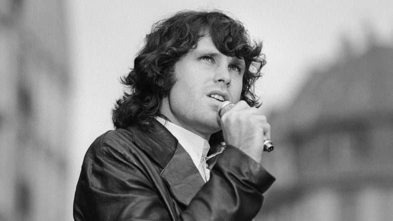 Jim Morrison singing outside in leather jacket