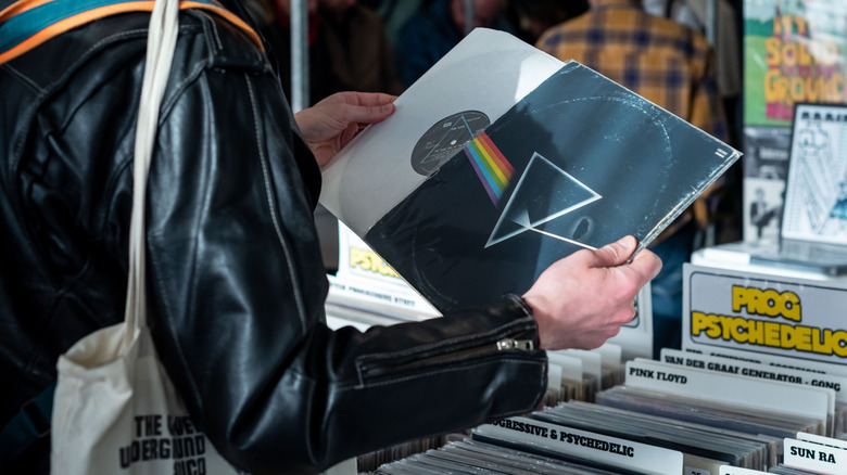Man holding vinyl of Pink Floyd's 