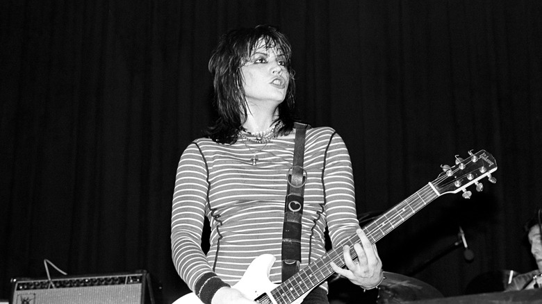 Joan Jett playing guitar on stage
