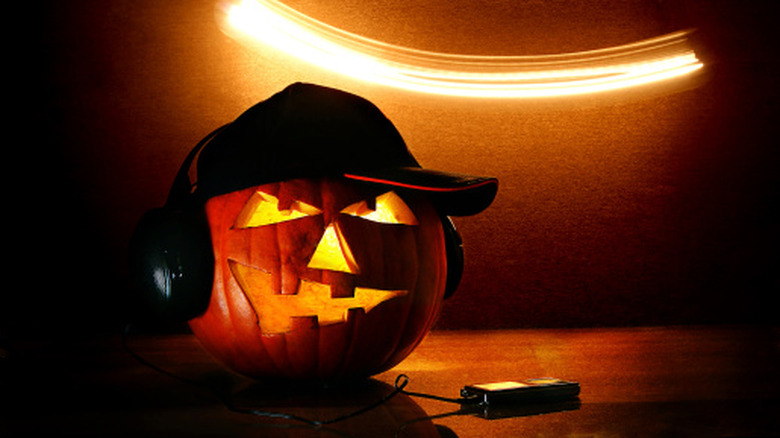 Jack-o'-lantern with hat and headphones on