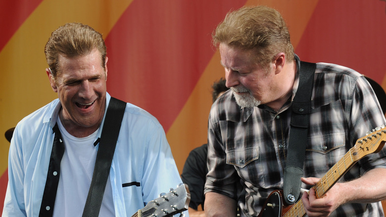 Don Henley and Glenn Frey onstage with guitars