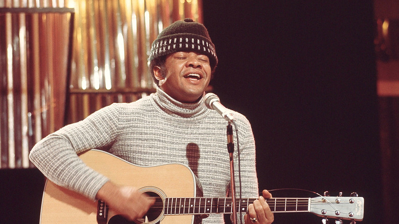 Bill Withers posing and looking into the camera.