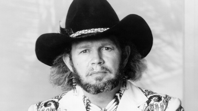 A press photo of David Allan Coe wearing a cowboy hat.