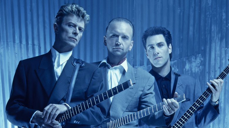 David Bowie and members of Tin Machine posing with guitars