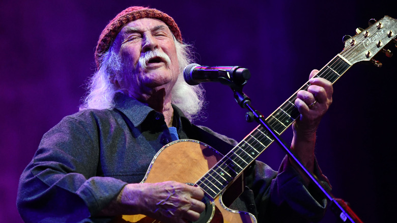 David Crosby of the Byrds playing guitar on stage