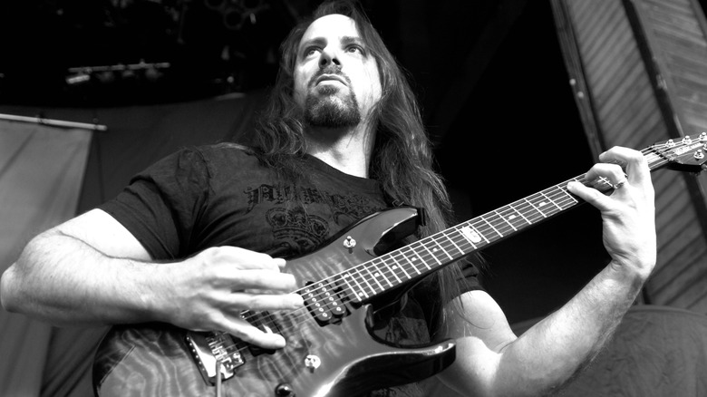 John Petrucci performing live while looking off into the crowd