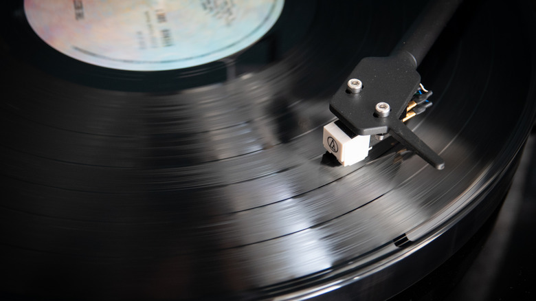 An Audio-Technical cartridge against a vinyl record