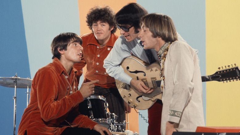 The Monkees performing together on stage