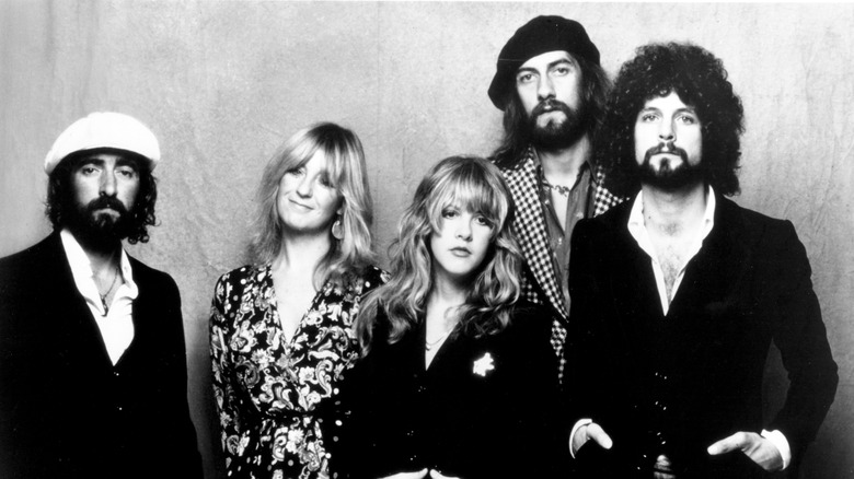A black and white photo of Fleetwood Mac standing together