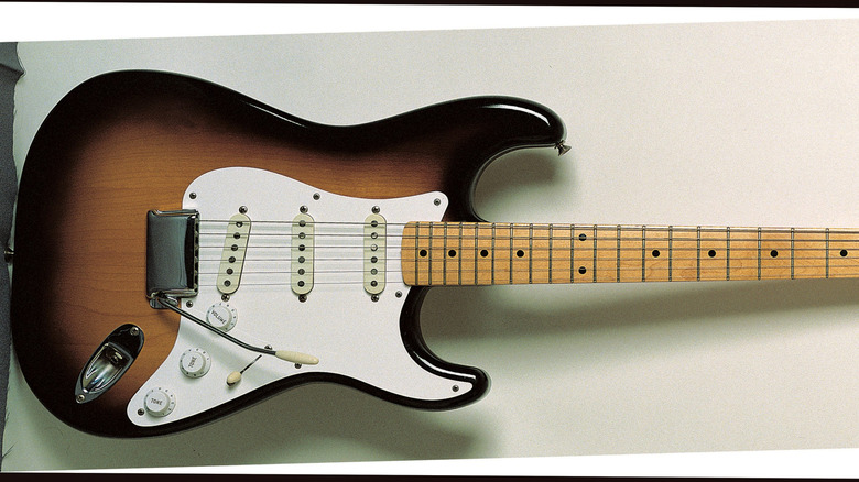 '57 Fender Stratocaster hanging in glass case