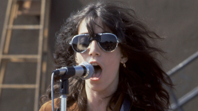 Patti Smith singing and playing guitar onstage in the 1970s