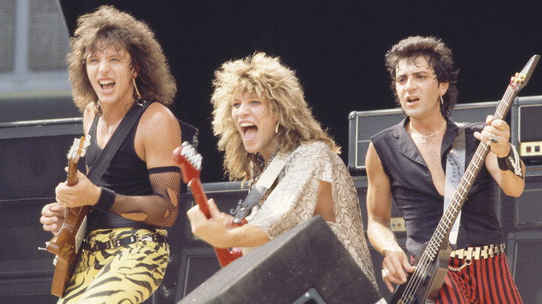 bon jovi performing on stage with big hair in the '80s