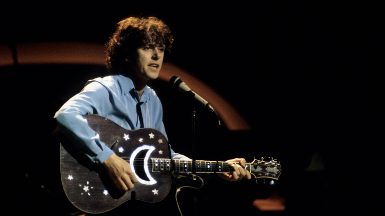 Donovan on stage with star-decorated guitar