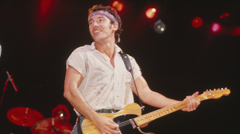 Bruce Springsteen plays guitar in concert, c. 1984