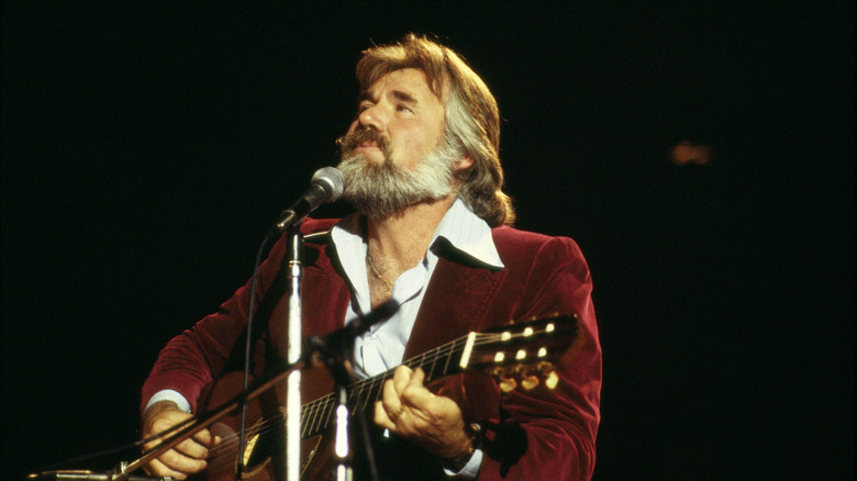 Kenny Rogers singing and playing acoustic guitar