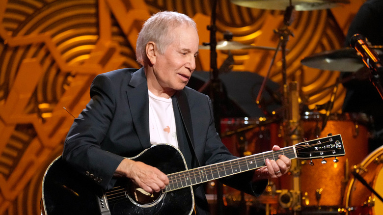 Paul Simon onstage with guitar