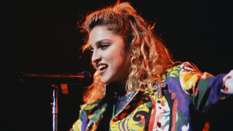 Madonna performing in multicolor jacket on stage in 1985