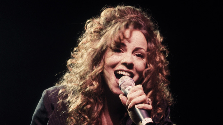 Mariah Carey singing into microphone