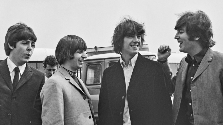 The Beatles smile in a 1965 photo