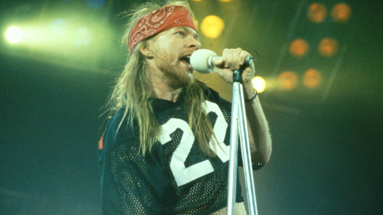 Axl Rose of Guns N' Roses holding a microphone