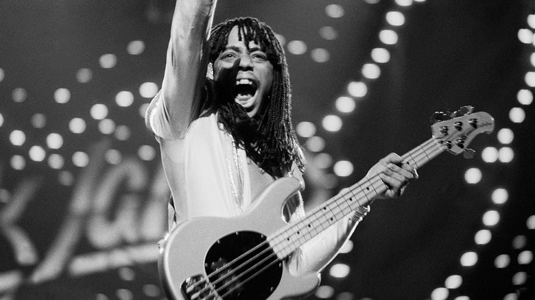 Rick James with guitar pumping fist on stage