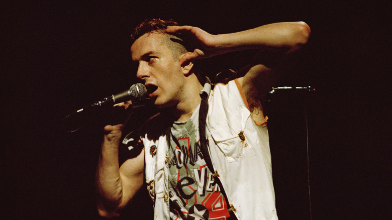 Joe Strummer of the Clash singing into mic