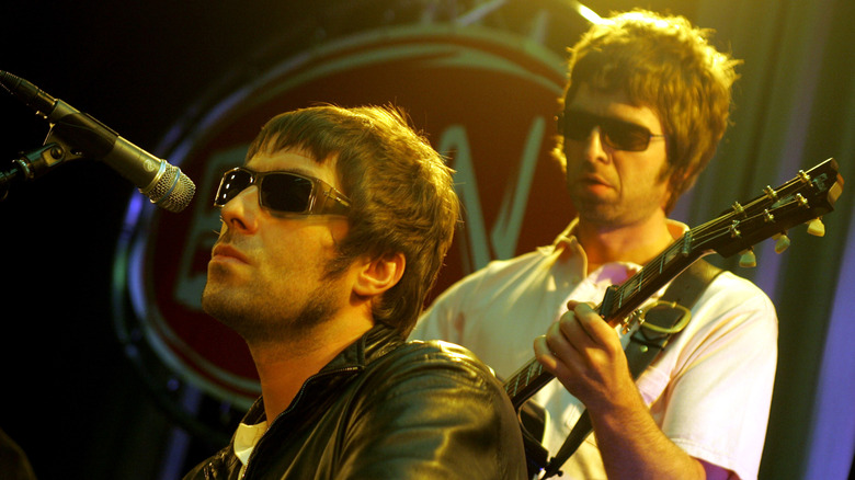 Liam and Noel Gallagher performing with Oasis