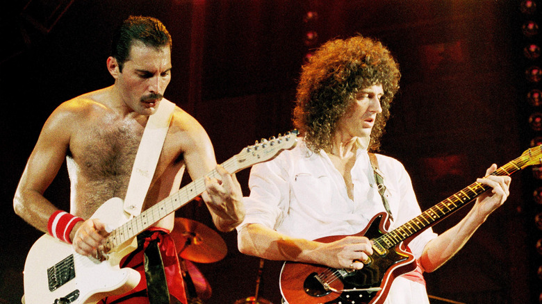 Freddy Mercury and Brian May playing guitars together during Queen performance