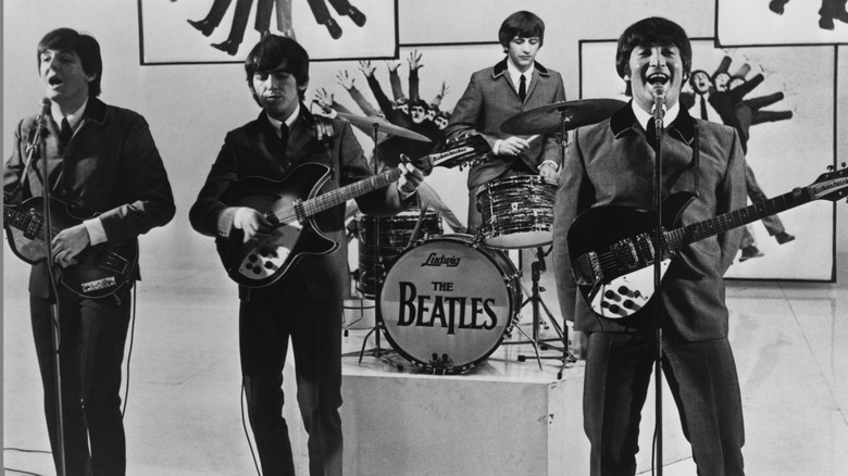The Beatles playing instruments on movie set