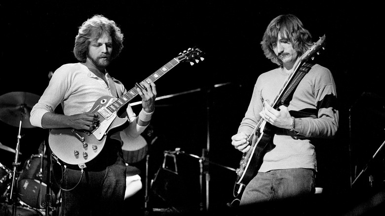 The Eagles playing guitars during live performance