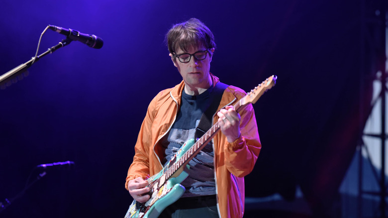 Rivers Cuomo onstage with guitar