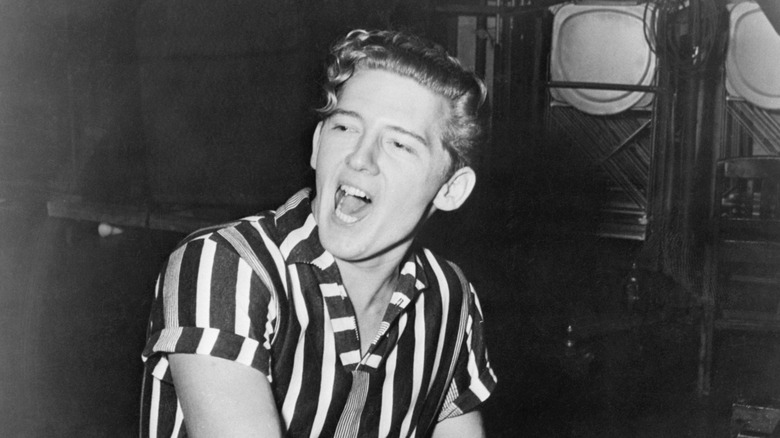Jerry Lee Lewis at piano in striped shirt
