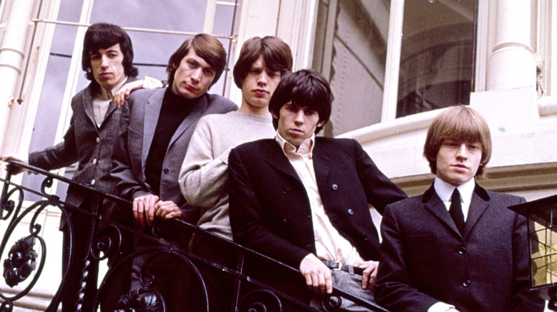 The Rolling Stones lined up on an exterior staircase in 1964