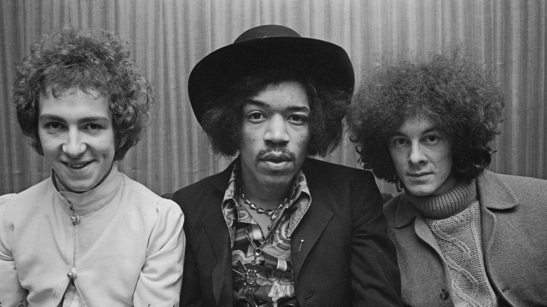 Members of the Jimi Hendrix Experience all looking at camera