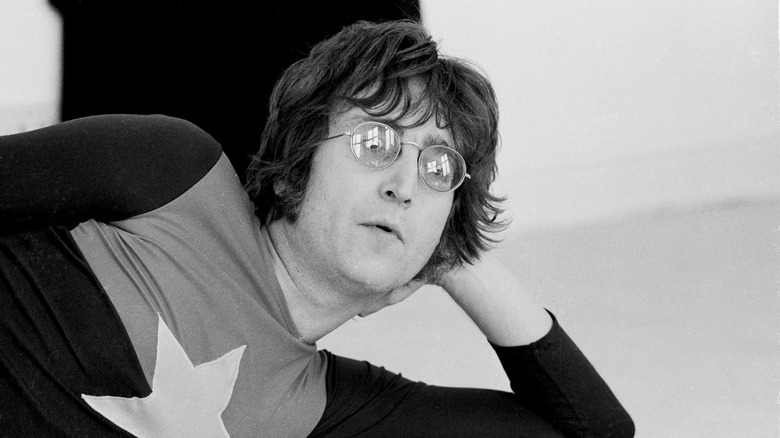 John Lennon reclining resting his head in his hand