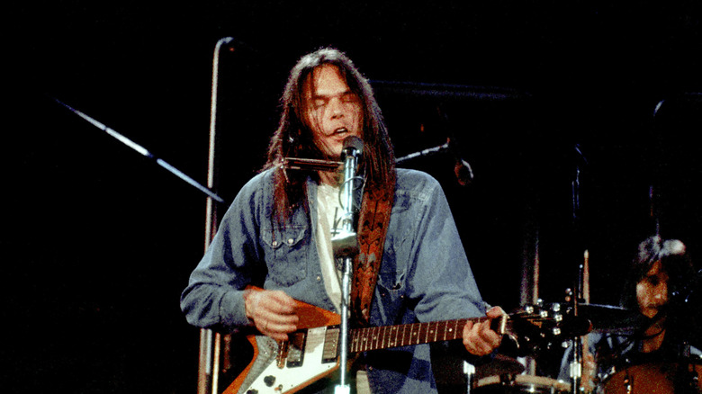 Neil Young onstage with guitar