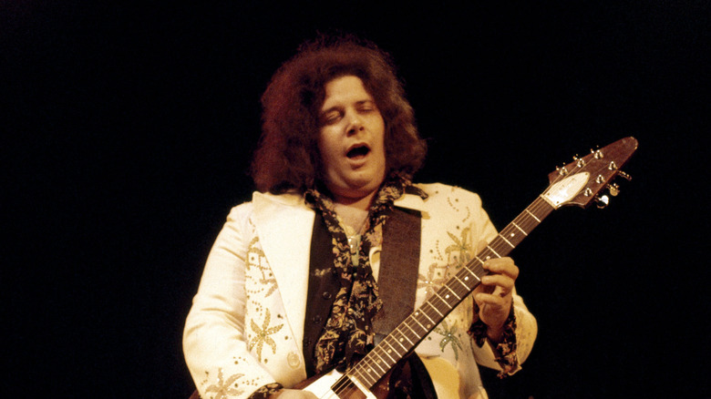 Leslie West singing and playing guitar on stage in the early 1970s