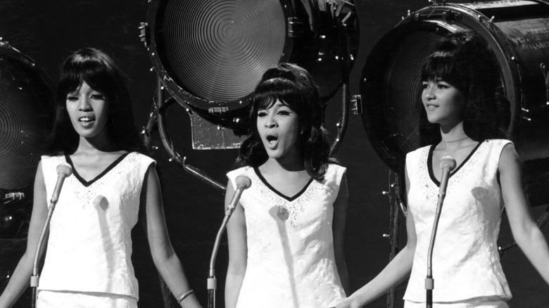 The Ronettes singing in front of stage lights
