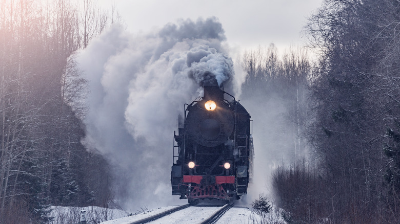 Old steam engine rolling down tracks
