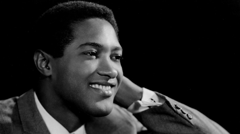 Sam Cooke smiling as he looks at someone